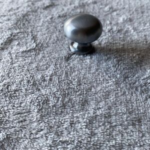 Set of 13 Brushed Nickel Round Drawer Pulls.